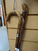 Three walking canes, one with hallmarked silver band