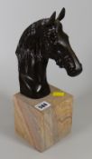 Bronze horses head on plinth