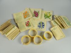 Four ivory monogrammed napkin rings dated 1868 & a collection of Kensitas silk cigarette cards