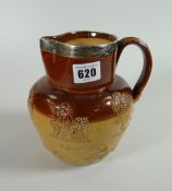 A Doulton Lambeth stoneware jug with hallmarked silver rim top