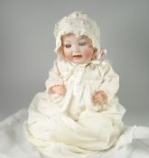 A GERMAN BISQUE HEAD DOLL BELIEVED BY HERTEL SCHWAB No. 152, having rolling eye-lids, open mouth,