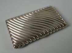 A CASED VICTORIAN SILVER AIDE-MÉMOIRE with raised swirl decoration, the silk lined interior with