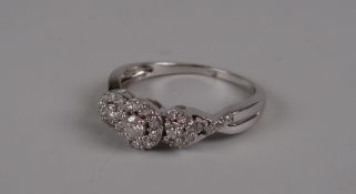 AN 18CT WHITE GOLD SET DIAMOND CLUSTER of fancy design, 4gms