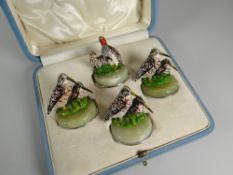 A PART-SET OF FOUR PAINTED BRONZE MENU HOLDERS each modelled as a different game bird on an onyx and