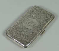 A FINE SILVER CALLING CARD CASE decorated with profuse foliate engraving surrounding a centre