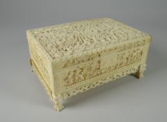 A FINELY CARVED NINETEENTH CENTURY IVORY CASKET the lid with a scene of multiple figures in a