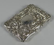 A CASED SILVER CALLING CARD CASE having a hinged lid and with raised foliate decoration