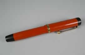 VINTAGE RED JUNIOR PARKER DUOFOLD LUCKY CURVE FOUNTAIN PEN with yellow metal trim (small mark on