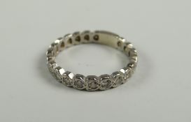 WHITE METAL DIAMOND SET ETERNITY RING having twenty-one diamonds, 4.2grms approx