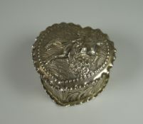 A VICTORIAN SILVER HEART-SHAPED BOX relief decorated all round, the lid with hunts-woman taking a