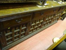 Substantial dark wood sideboard by Younger of London having four cupboards and three drawers