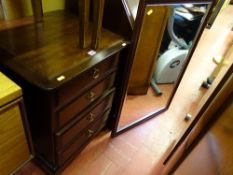 Stag chest of four drawers and a bevelled glass wooden framed mirror