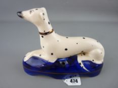 Staffs figure of a recumbent greyhound on a cobalt cushion