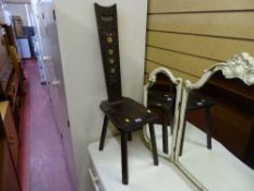 Dark wood spinning chair with carved highback inscribed '1977'