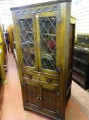 Corner cupboard with twin upper glazed doors over twin base cupboards and central drawer