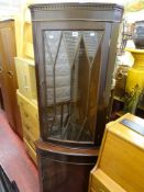 Corner cupboard with upper glazed door and a glass topped table