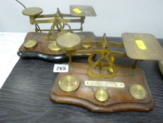 Two old sets of postage scales with accompanying weights