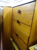 Teak mid Century bedroom suite of triple wardrobe with bi-folding door, five drawer chest and a