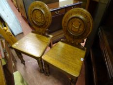 Pair of oak circular shieldback style hall chairs