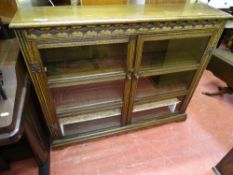 Bookcase cupboard with two x three section glazed doors and carved top