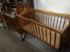 A modern oak crib, vintage roll top bureau (distressed) & a leather-style armchair