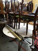 A reproduction mahogany circular extending dining table together with four matching chairs
