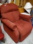 An electric reclining armchair with red patterned fabric E/T