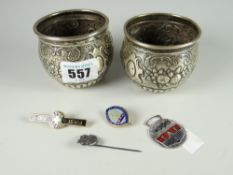 A pair of small embossed silver decorative pots