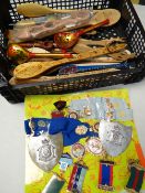 A collection of Buffalo Society medals together with a tray of novelty carved wooden spoons