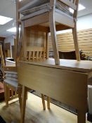 A modern lightwood drop leaf kitchen table & four matching chairs