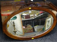 An oval mahogany mirror with bevelled glass