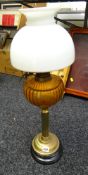 A brass table lamp in the style of an oil lamp