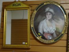 A gilt framed architectural hall mirror together with an oval portrait of a lady in a gilt metal