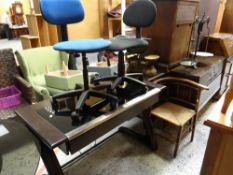 A modern darkwood & smoky glass top single-drawer desk together with two office chairs & a corner