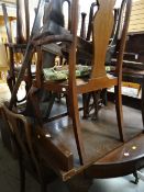 An early twentieth century mahogany extending dining table on profusely carved ball & claw legs