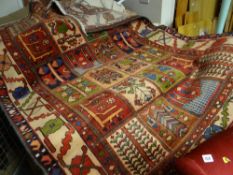 A large red ground patterned rug together with two smaller rugs