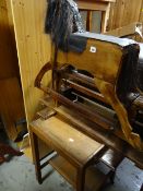 A vintage stained wood rocking horse together with an occasional table