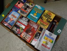 A box of paperback novels, mainly war related