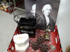 A crate of metal items including a kitchen mincer, set of weights, bread bin & reproduction cast
