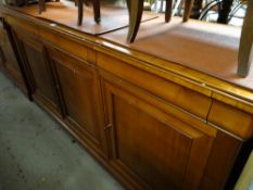 A modern polished wood sideboard by Grange, three doors above a three three cupboard base