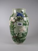 A green glazed Oriental-style vase with flowers & a blue bird