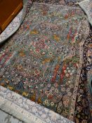 A large Persian-style green ground rug together with another small rug