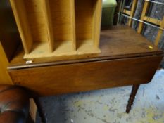 An antique mahogany drop leaf table
