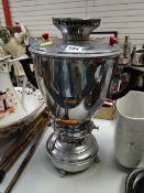 A large modern stainless steel tea urn