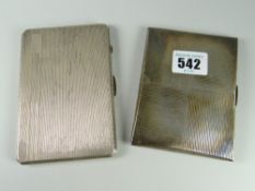 A pair of engine turned silver cigarette cases