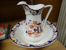 A large pottery jug & basin set with an Oriental red & blue design