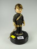 A small decorative soldier in the form of a musical box