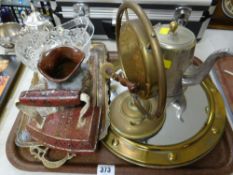A circular brass porthole-style mirror, small decorated brass tray, glassware etc