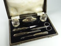 A cased hallmarked silver ladies manicure set with nail file, nail buffer, scissors etc