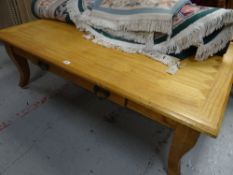 A large lightwood patterned top coffee table with centre drawer